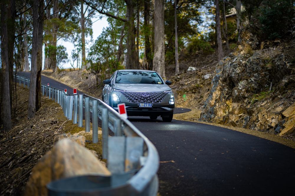 Car driving down driveway to mountain forest retreat