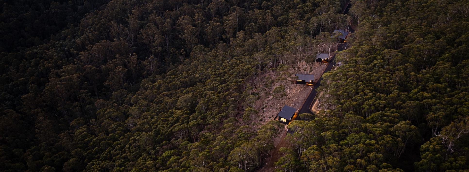 Drone picture of 3 cabins overlooking the forest