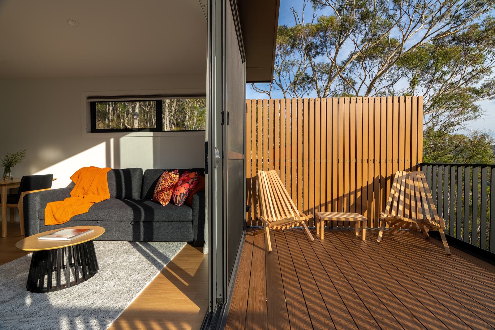 Split screen between living room and deck of ironbark cabin