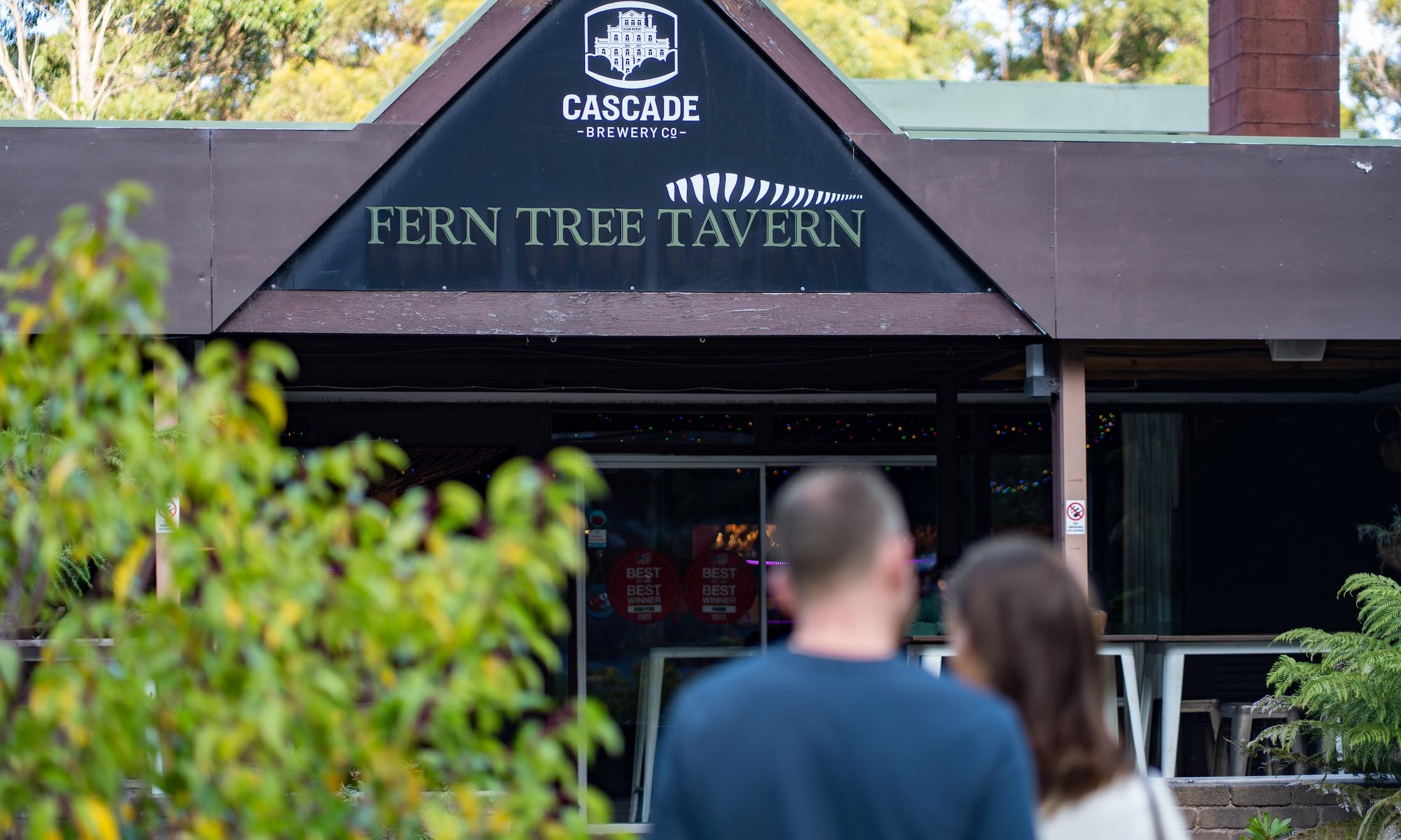People walking in to Fern Tree Tavern