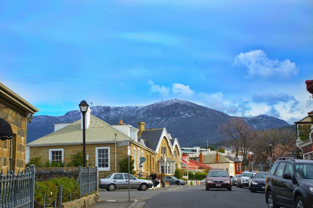 View down street in battery point showing sandstone buildings and view of kunanyi